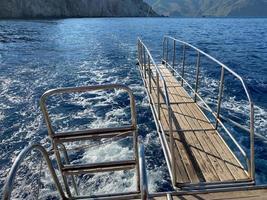 teak and stainless steel gangway at the bow of a pleasure boat photo