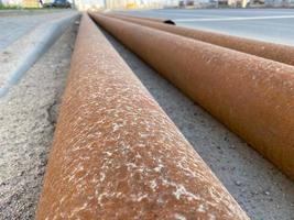 A dirty steel table with a rusty steel casing pipes on the background photo