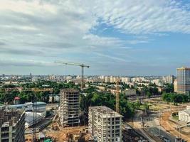 construction of a new neighborhood in the city. erection of new houses with a crane. high buildings for the life of people from concrete blocks photo