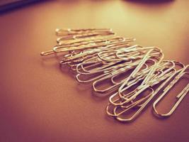 Gold paperclips isolated on a white background photo