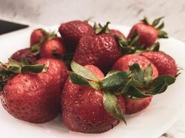 Juicy and tasty ripe strawberry on a dining table. Beautiful and tasty sweet berry photo