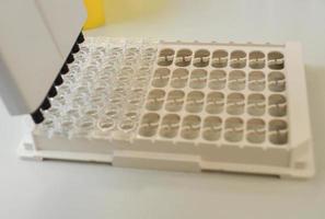 Dna test in the lab. a laboratory technician with a dispenser in his hands is conducting dna analysis in a sterile laboratory photo