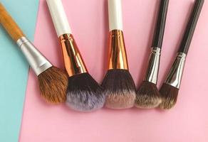 brushes lie on a bright background. fluffy brushes with natural bristles for applying textures to the face. beautiful face, brushes for eyeshadow, powder and blush photo