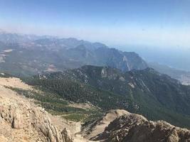 Beautiful landscape view from a high mountain to the forest and mountains in a tropical country with resorts and the sea photo