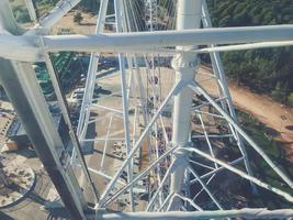 large, heavy, massive armature of white color. the base of the carousel in the park is the ferris wheel. riding an attraction on a sightseeing tour photo