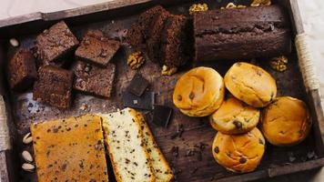 Different kinds of cakes arranged on a wooden tray video