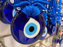 Traditional Turkish souvenir lucky amulet, view through the window glass gift shop. Photo depicts Turkish eye glass symbol, protection from evil