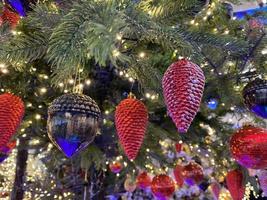 Balls, cones, stars on the Christmas tree. Close-up photo