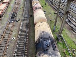 Top view of different railway wagons and tanks on an industrial railroad with rails for the transport of goods and improved modern logistics photo