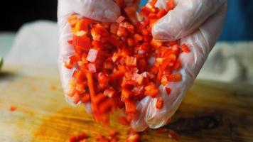 I hold a Sweet Red Kapia Peppers cut into small pieces. Macro shooting video