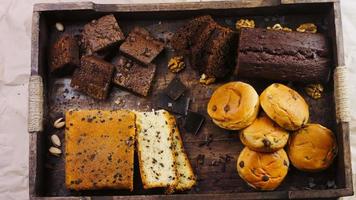 Different kinds of cakes arranged on a wooden tray video