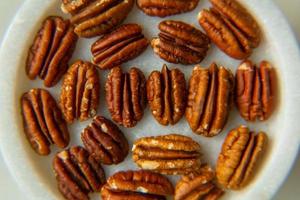 Walnut plan, pecan halves on a beautiful stand, Nuts are healthy. photo