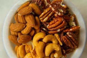 Mix Walnuts, pecan, almonds, cashews on a beautiful stand, Healthy Nuts. photo