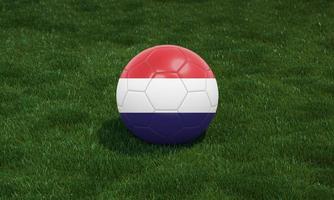 Soccer ball with Netherlands flag colors at a stadium on green grasses background. photo