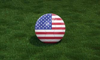 Soccer ball with USA flag colors at a stadium on green grasses background. photo