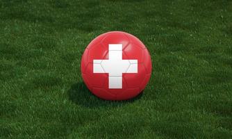 Soccer ball with Switzerland flag colors at a stadium on green grasses background. 3D illustration. photo