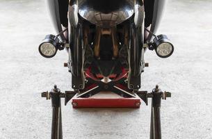 Front view motorcycle up to stand to remove wheel to change tire photo