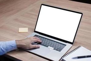 Businessman put your hand on keyboard and white screen background mock up on display laptop with clipping path photo