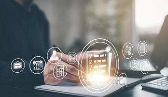 Online documentation database and document management system concept, Businessman using tablet or computer,Document Management System and Automation software to archiving and efficiently manage. photo
