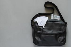 Carry bag with mask, alcohol spray and sanitizer hand gel. photo