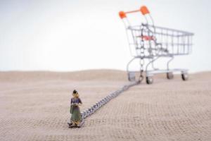 Woman figurine attached to a Shopping cart photo