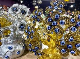 A beautiful golden figurine of a shiny oriental decorative bauble with Turkish eyes from the evil eye in a tourist souvenir shop photo