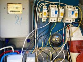 Homemade electric control cabinet for electronic devices at home with circuit breakers and counters in an iron box photo