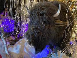 Toy bull. Symbol of the Chinese New year 2021. Merry Christmas and New year background. Close-up, selective focus photo