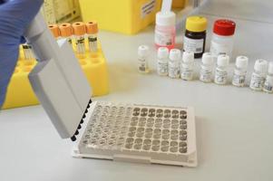 Woman with lab flask at her workplace stock photo