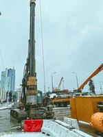 construction of a new bridge in the city center. the accumulation of workers and construction equipment at the construction site of the construction bridge. overpass construction photo