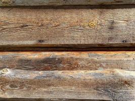 Brown wood texture of natural wood from horizontal planks with knots. The background photo