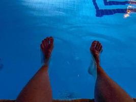 relajarse en la piscina. hombre relajante junto a la piscina. hombre disfrutando del caluroso verano foto