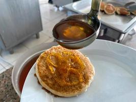 Pancakes for breakfast are fluffy floury delicious poured with honey from a spoon in a canteen cafe. The background. Texture photo