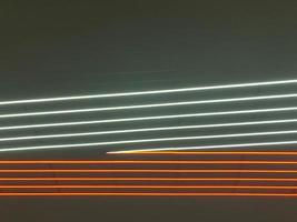 textura de neón brillante rojo y blanco con rayas y líneas abstractas láser multicolores de lámparas paralelas. el fondo foto