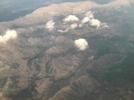 Beautiful view on the mountains from the top through the clouds photo