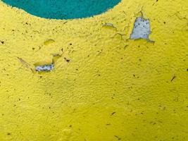 Texture of iron metal painted bright green peeling paint of old battered scratched cracked ancient rusty metal sheet wall photo