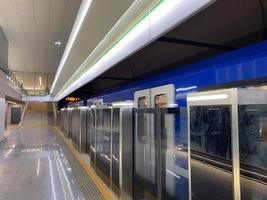 New blue modern subway train high speed fast safe in the big city on the waiting platform at the subway station at the train station photo