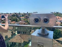Binoculars for tourist inside the building and city background. photo