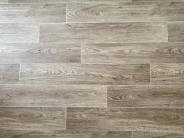 Fragment of vinyl flooring with wooden planks embossed imitation photo