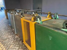 Large iron upside down clean empty iron bins with wheels to separate waste and recyclable paper, plastic and food waste photo