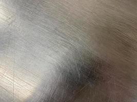 Texture of a shiny chrome-plated metal iron surface with minor scratches and abrasions. The background. Texture photo