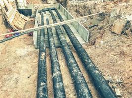 black, polypropylene, long pipes are laid underground for communications. construction of a new microdistrict with houses and sewerage photo