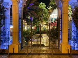 Large gates with stone columns in Greek and Roman antique style at night photo