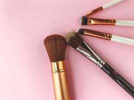 brushes lie on a bright background. fluffy brushes with natural bristles for applying textures to the face. beautiful face, brushes for eyeshadow, powder and blush photo
