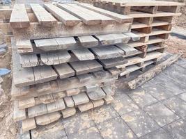 wooden pallets at the construction site. natural material for carrying heavy objects at a construction site. pallets for storage of building materials photo