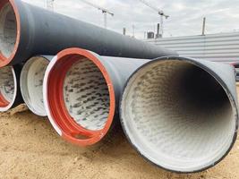 polypropylene pipes made of black material lie on a construction site. laying plumbing communications in a new residential area of the city photo