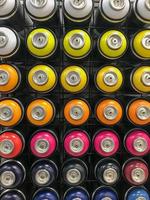 Many bright beautiful multi-colored spray paint cans for painting photo