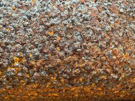 Surface texture of old metal iron swollen reddish orange surface of rusty bad pipe. Close view. The background photo