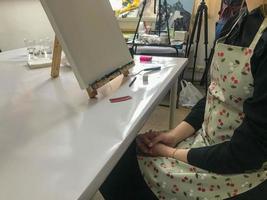 Small table with tools and paints in artist s workshop photo