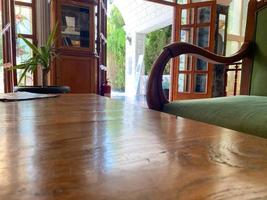 An old wooden antique armchair in the lobby of the hotel near the waiting table photo